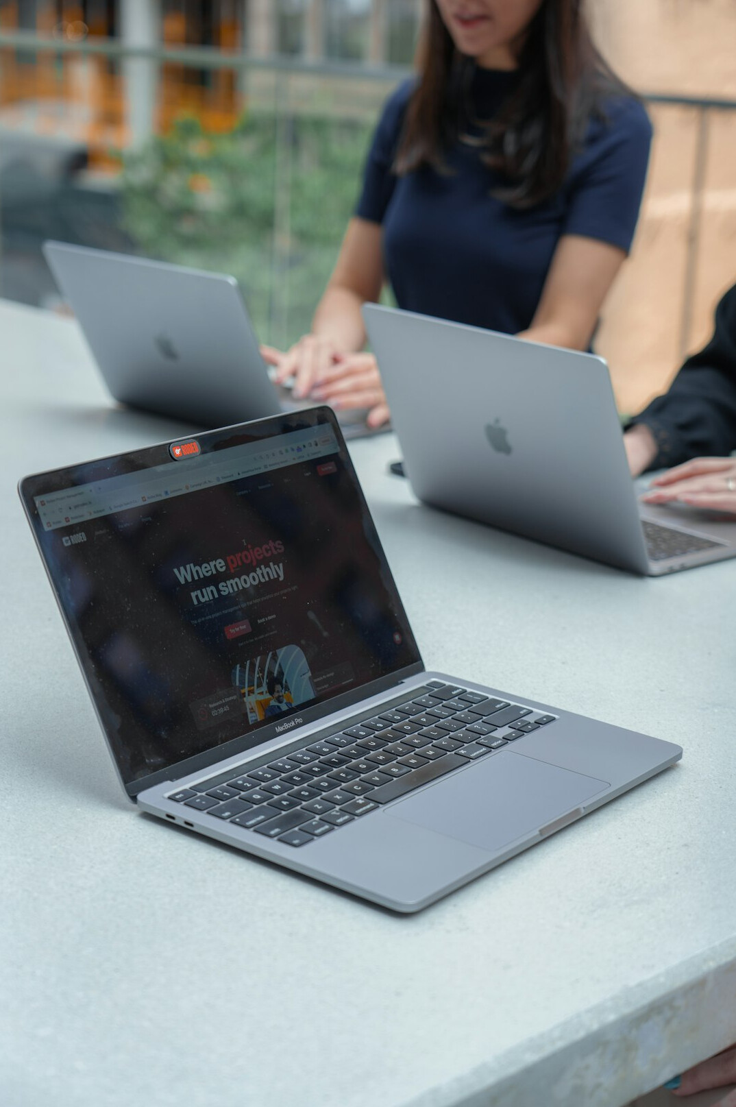 group of friends coding on laptops